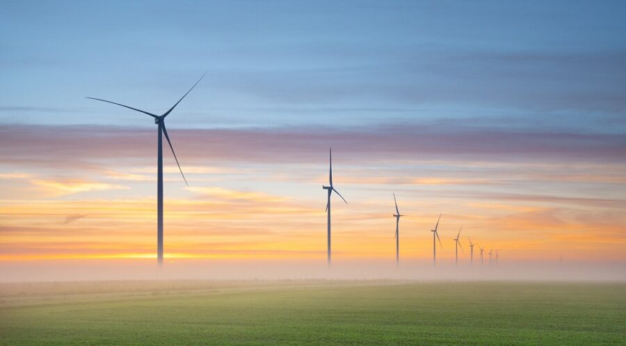 Wind farm with turbines against a pastel sky