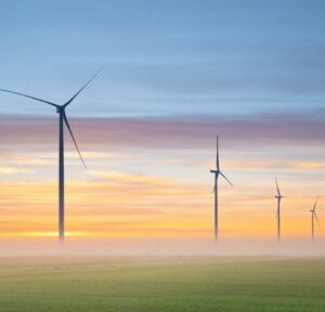 Wind turbines on farmland at sunrise